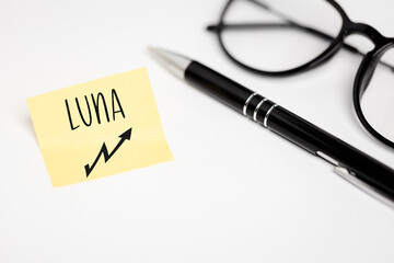 A yellow piece of paper on a white background with a handwritten inscription 