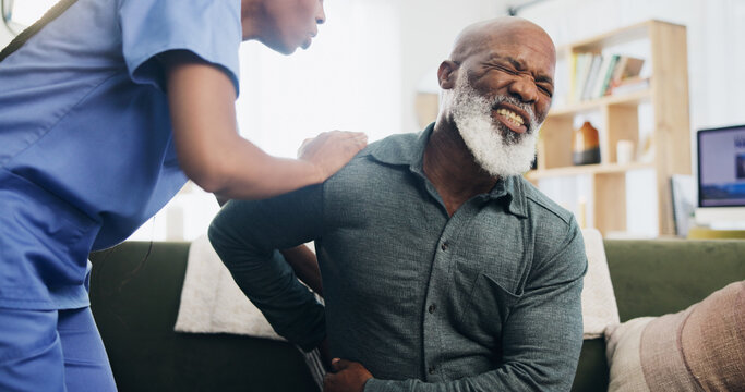Nurse, senior man and back pain in home with help, care or support for recovery from injury in retirement. Black people, physical therapy and elderly person with disability, muscle and rehabilitation
