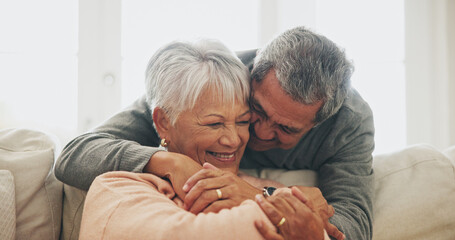 Hug, relax and senior couple with love, home and care with happiness, funny and bonding together. Apartment, embrace and mature woman with elderly man on sofa, retirement or comfortable in lounge