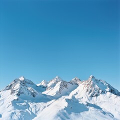 Breathtaking view of snow-covered mountains under a clear blue sky, perfect for nature lovers and adventure enthusiasts.
