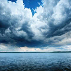 Obraz premium Dramatic cloud formations over a serene body of water, capturing the beauty of nature's ever-changing sky.