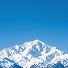 Majestic snow-capped mountain peaks under a clear blue sky, perfect for nature and adventure photography.
