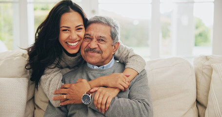 Hug, portrait and smile of old man with daughter on sofa in living room of home for bonding or visit. Face, family or love with happy woman and senior father embracing in apartment together