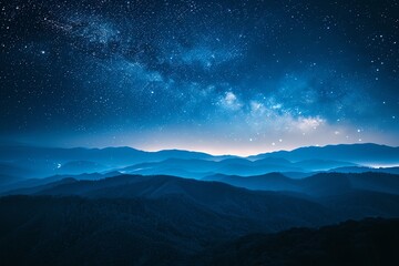 Fototapeta premium Serene night landscape with a starry sky over misty mountains, creating a tranquil and majestic atmosphere.