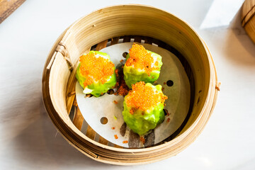 Chinese Dimsum in bamboo basket. Dimsum is a large range of small dishes that Cantonese people traditionally enjoy in restaurants for breakfast and lunch.