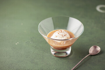 Ice cream ball with irish coffee liqueur. Alcoholic affogato. Summer cocktail.