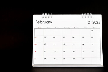 Desk Calendar for February 2025. Desktop calendar on a black background.