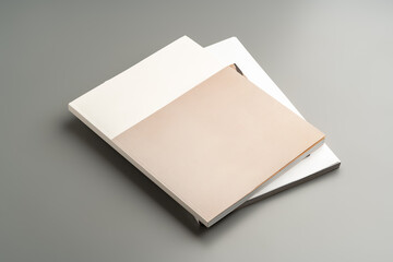 A minimalistic design showcasing an open book resting on a gray surface in soft lighting