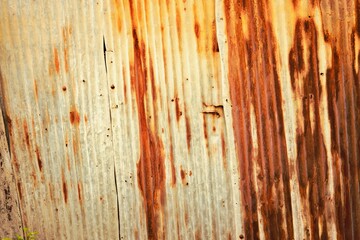 The image is of a rusted metal surface with a lot of scratches and dents. The surface appears to be...