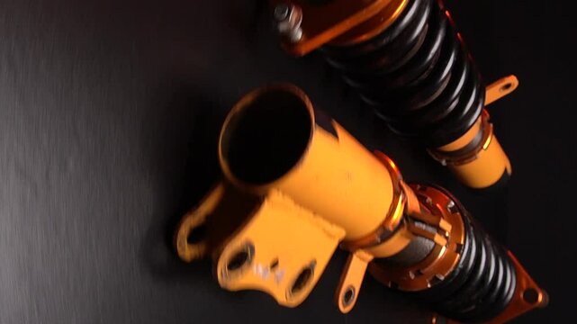 suspension tuning not new coilovers, shock absorbers and front springs in yellow and gold colors for a sports drift car on a dark background
