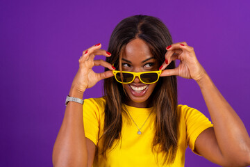 Confident and playful african woman with sunglasses