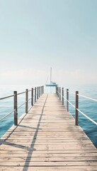 Fototapeta premium Serene wooden dock extending into tranquil blue sea with distant sailboat under clear sky
