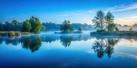 In the stillness of the early morning, the pond's surface is a perfect mirror, reflecting the misty blue atmosphere, with a few subtle ripples adding a touch of movement.