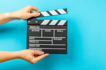 Movie clapper. Movie clapper in hands on bright colored background. Concept of rest and...