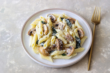 Penne pasta with mushrooms, spinach and cheese. Healthy food. Vegetarian food.