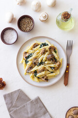 Penne pasta with mushrooms, spinach and cheese. Healthy food. Vegetarian food.