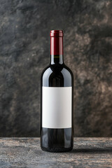 Fototapeta premium Minimalist Wine Bottle with Blank Label on Stone Background