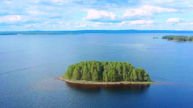 Aerial view of of islands on a blue lake. Blue lake, islands and green forest from above on a sunny summer day. Lake landscape in Sweden Scandinavia