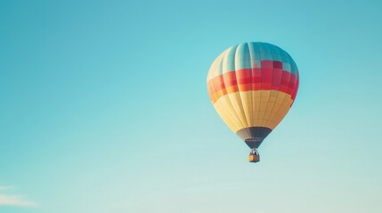 Fototapeta premium A clear blue sky with a colorful hot air balloon floating peacefully, capturing the essence of adventure.