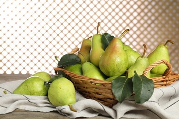 Fresh green pears and leaves on wooden table, closeup