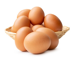 Group of fresh brown chicken eggs in stack in wicker basket isolated on white background with clipping path
