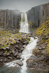 Waterfall flanked by basalt columns