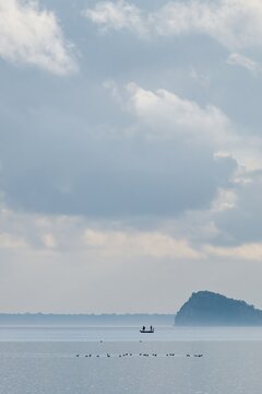 Bisentina island on the middle of Bolsena lake at sunset in Italy