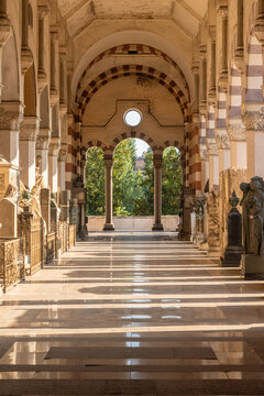 perspective view of one of the corridors with columns and arches at the cemetery of Milano, in Italy