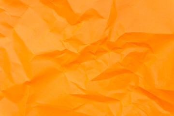 Top view and full frame of wrinkled or crumpled orange paper texture used as crumpled paper background texture in decorative art work