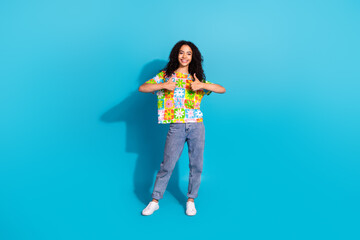 Full length photo of cheerful pretty lady dressed flower print t-shirt showing two thumbs up empty space isolated blue color background