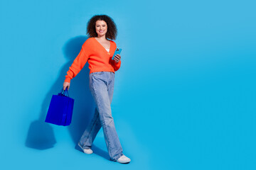 Photo portrait of wavy haired model woman using smartphone order gifts online going from shopping...