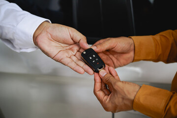 In a showroom, people engage in buying or leasing cars, working with salespeople to finalize contractsDiscussions involve choices agreements financingThe process includes paperwork explaining terms