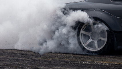 White smoke from tire, Car burnout wheels tire with white smoke,Car wheel burnout with smoke from...