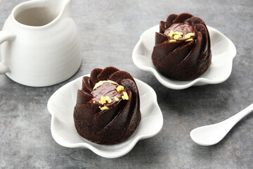 Chocolate cake topped with cream cheese and melted chocolate
