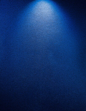Dark blue wall gradient. HD quality. Gentle illumination falls from above, highlighting subtle texture variations, deepening shadows, creating a captivating visual contrast, and enhancing the rich, in