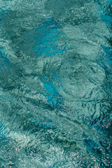 Blue water surface with bright sun light reflections, water in swimming pool background 1