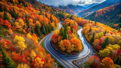 Dramatic overhead perspective showcases mountain road curving through valley, surrounded by riot of autumn colors, with crisp leaves and sparkling dew drops.