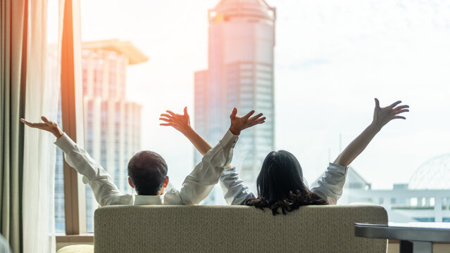 Relaxing couple lifestyle celebrating happy resting in luxury city condominium, urban condo, home apartment, or business hotel tower for family life-work balance and marriage living quality concept - Powered by Adobe