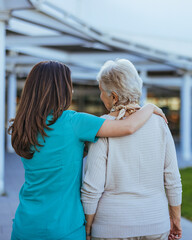 Healthcare Professional Comforting Senior Woman Outdoors
