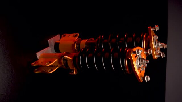 suspension tuning not new coilovers, shock absorbers and front springs in yellow and gold colors for a sports drift car on a dark background vertical video