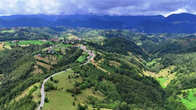Aerial view Pestera village on top of a hilly countryside in Transylvania