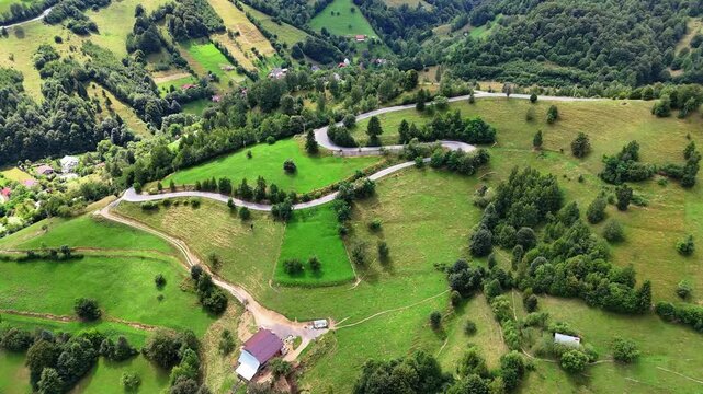 Aerial view of a winding road in the Romanian countryside