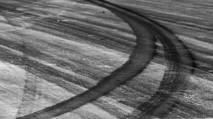 Tire track mark on asphalt tarmac road race track texture and background, Abstract background black...