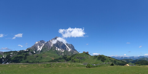 Fototapeta premium Majestic mountain landscape with green hills and clear blue sky