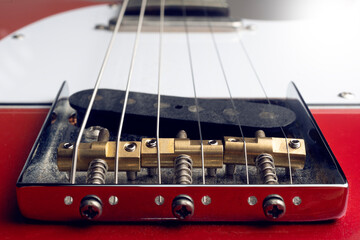Perspective view of an electric guitar bridge with brass saddles