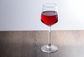 Red wine glass on a wooden table