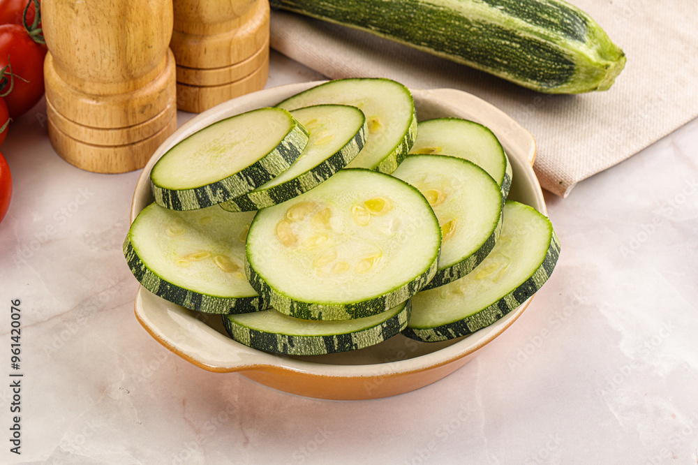 Wall mural Raw green zucchini slices for cooking