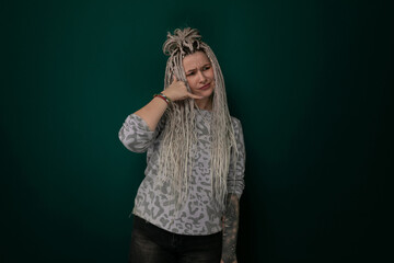 Woman With Long Blonde Hair Standing in Front of Green Wall