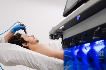 Cosmetology clinic. Professional female cosmetologist doing hydrafacial procedure while working....