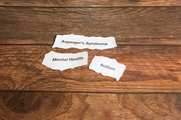 Mental health disorders on strips of paper on wooden table. 